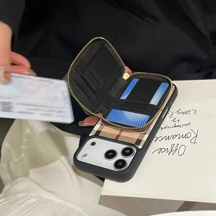 Phone case with card slots and zipper pocket on a surface