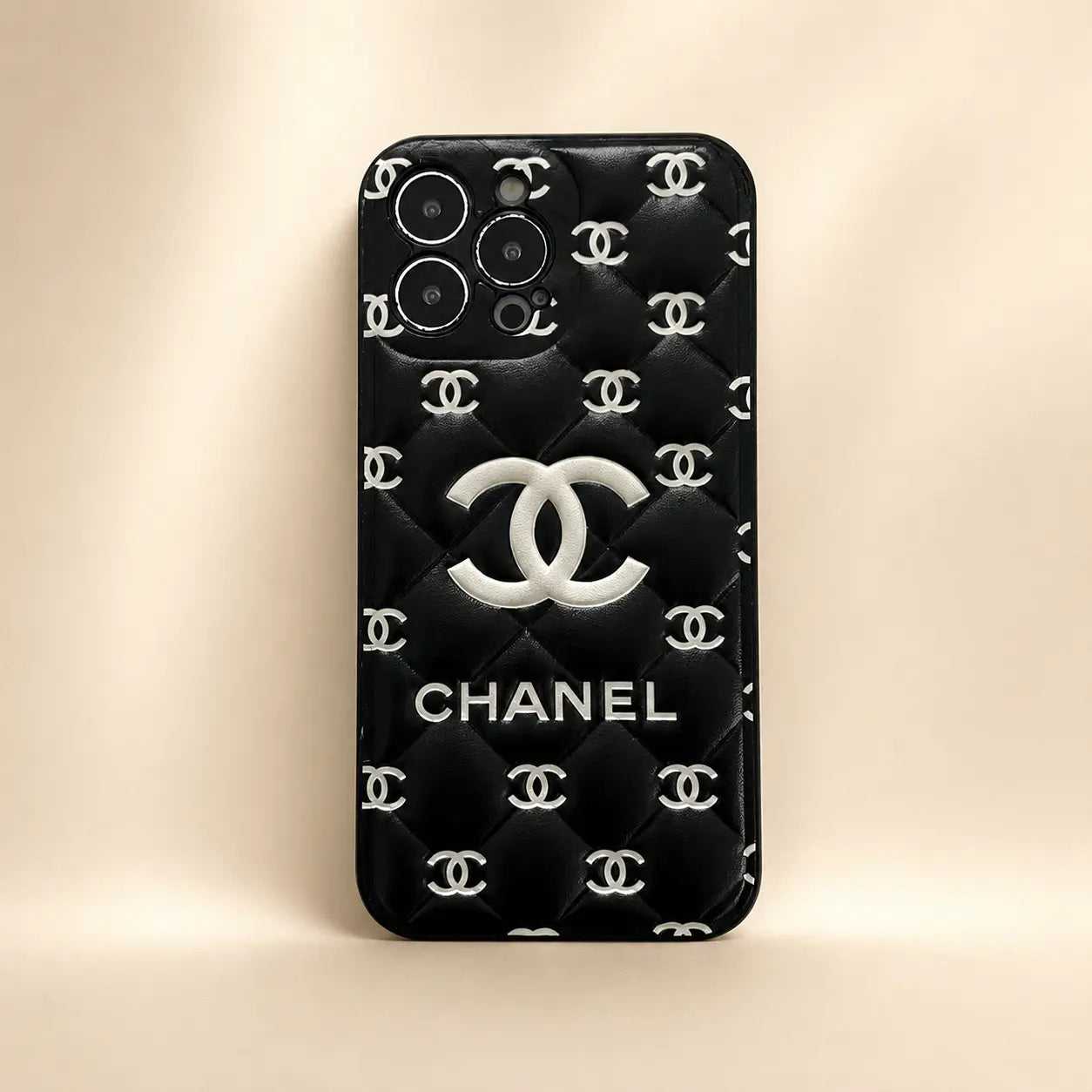 Chanel phone case with quilted design and logo on a beige background
