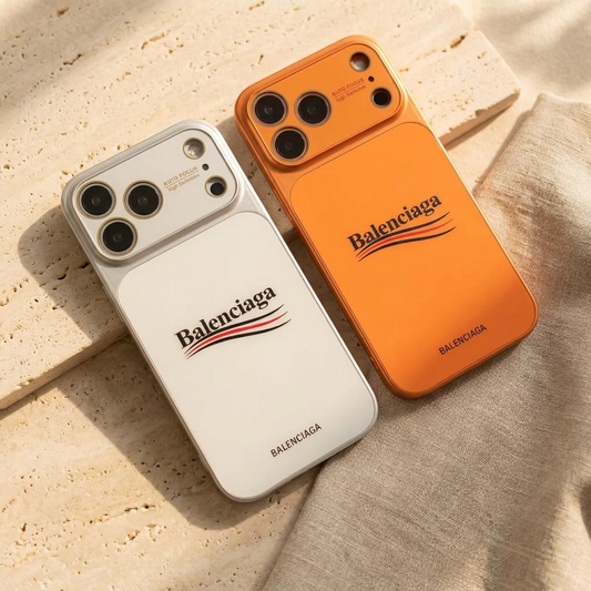 Silver-toned White and orange back covers lying diagonally side by side, showing their wordmark designs and colour-matched camera surrounds.