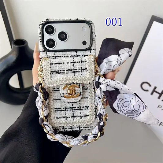 Phone case with Chanel design and matching scarf held by a hand