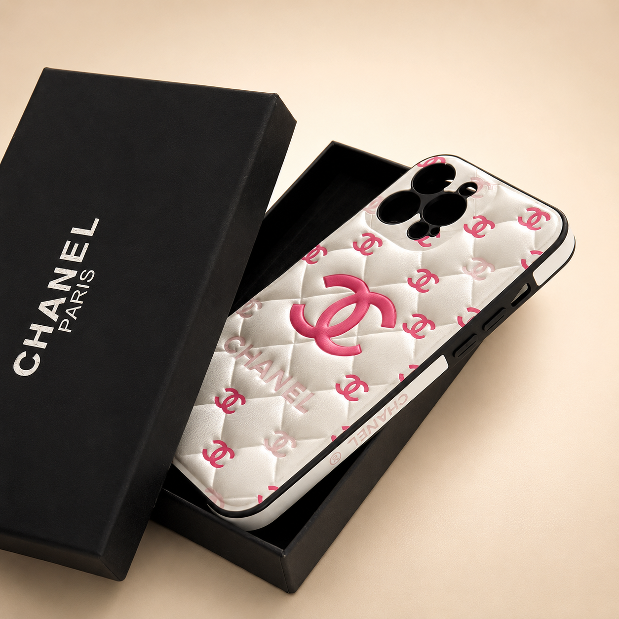 Chanel phone case with pink logo in a black box on a beige background