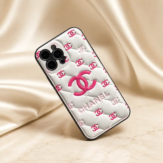 Phone case with Chanel logo on a beige fabric background