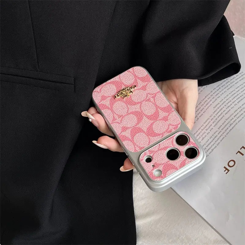 Coach iPhone case Person holding a pink phone case with a brand logo