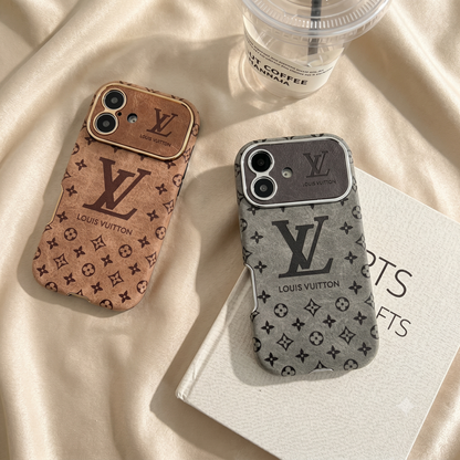 Louis Vuitton iPhone Case – Premium Leather Cover iPhone Case 17 Pro max | Black & Brown Two Louis Vuitton phone cases on a beige fabric background with a coffee cup.