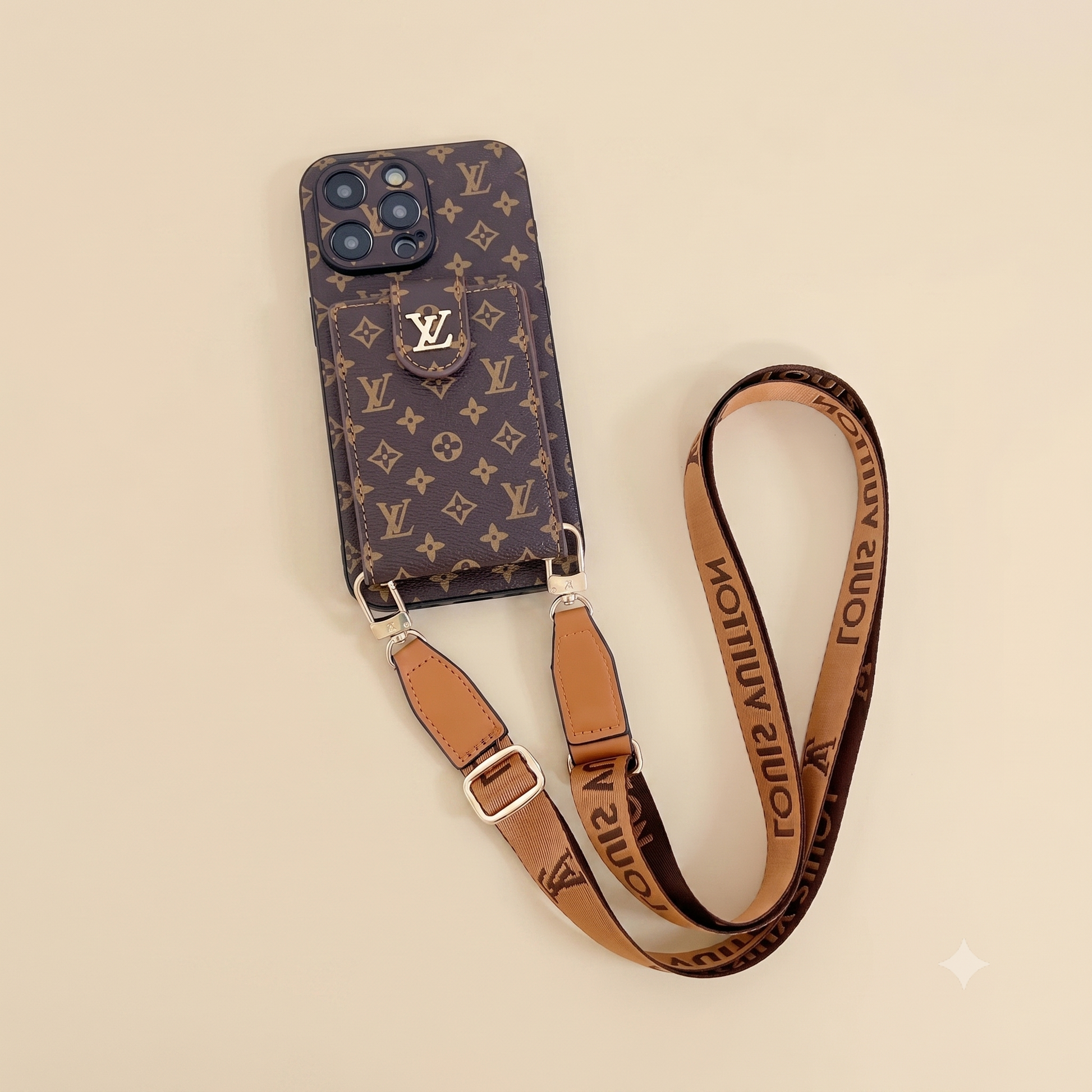 Phone case with monogram pattern and matching strap on a beige background