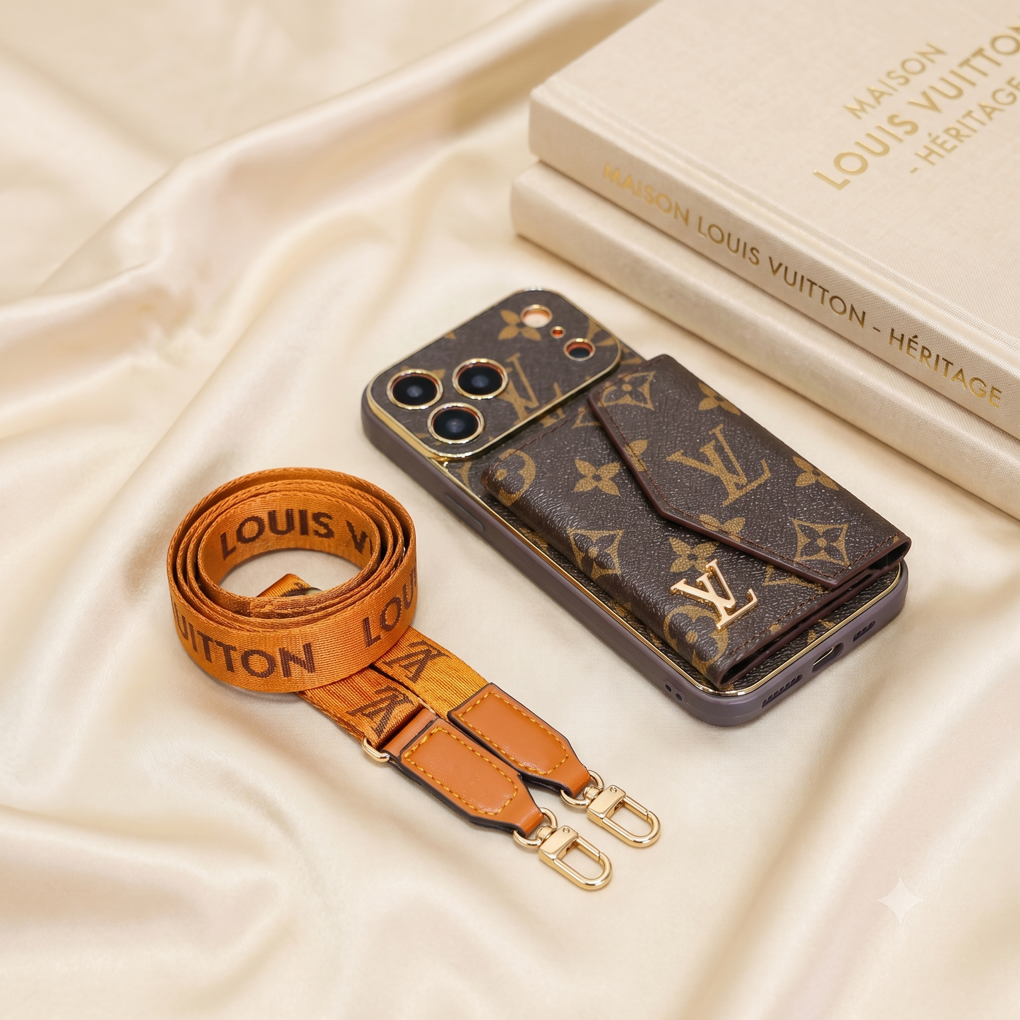 Louis Vuitton phone case and strap on a beige fabric background