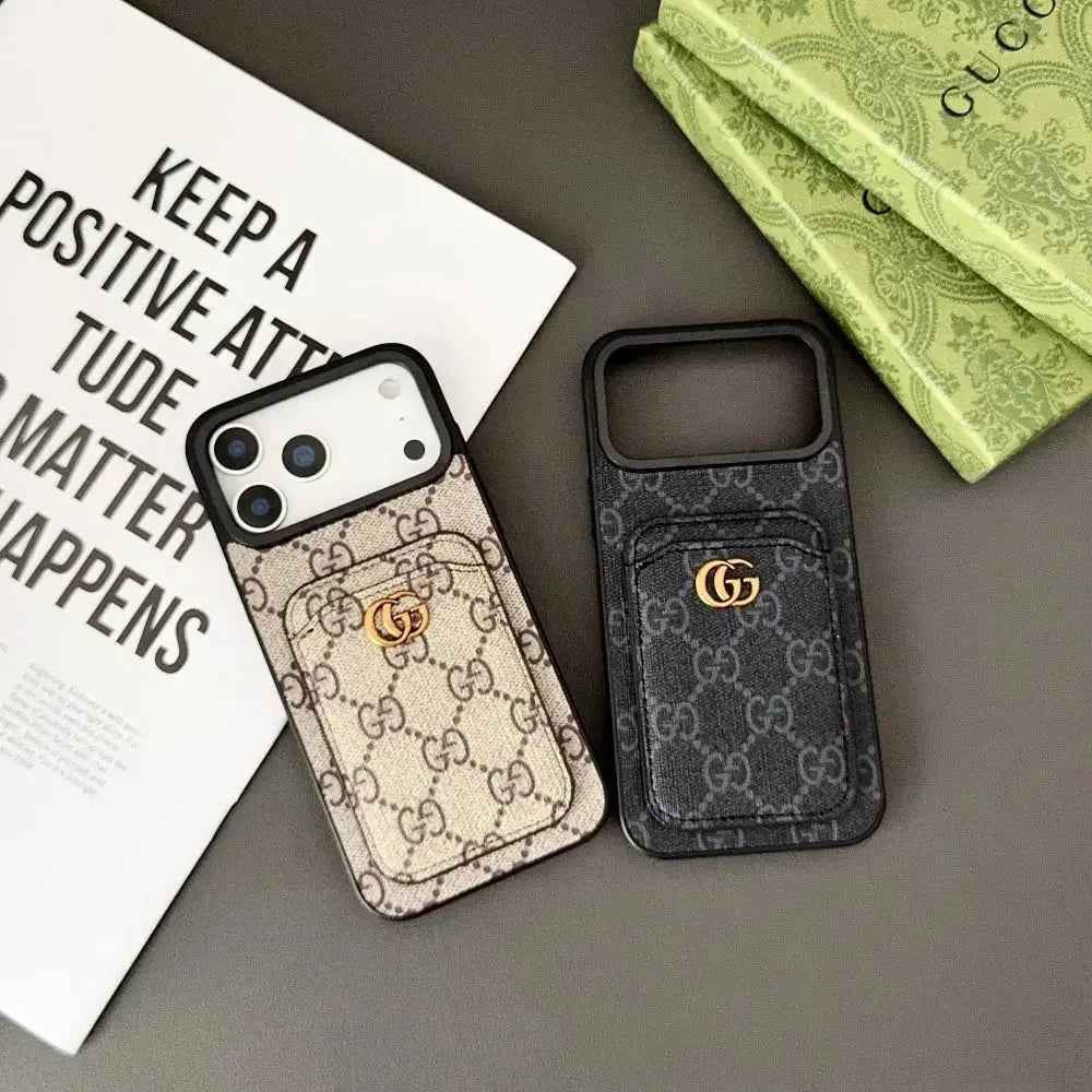 Original beige and dark GG monogram design cases with stitched rear card pockets and gold-coloured GG emblems; beige holds a display phone.