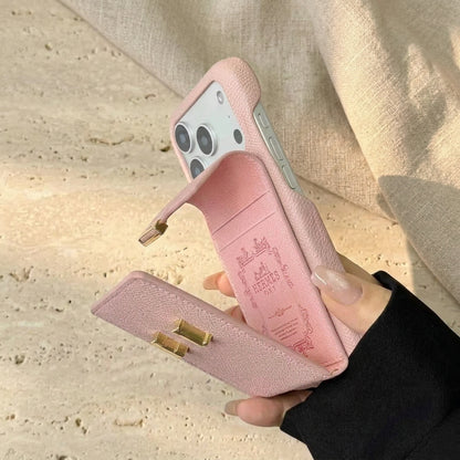 Pink iPhone case with the rear card pocket flap open, held over cream travertine.