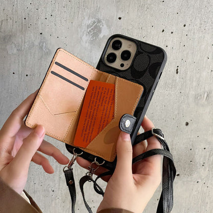 iPhone case with detachable strap held by hands against a concrete wall background