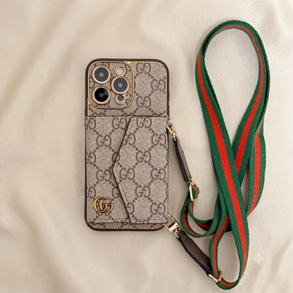 iPhone case with Gucci logo and matching green and red strap on a beige background