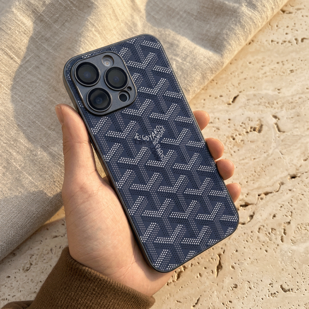 Hand-held deep navy blue back cover with light dotted chevrons, central name detail and dark coordinating camera surround.