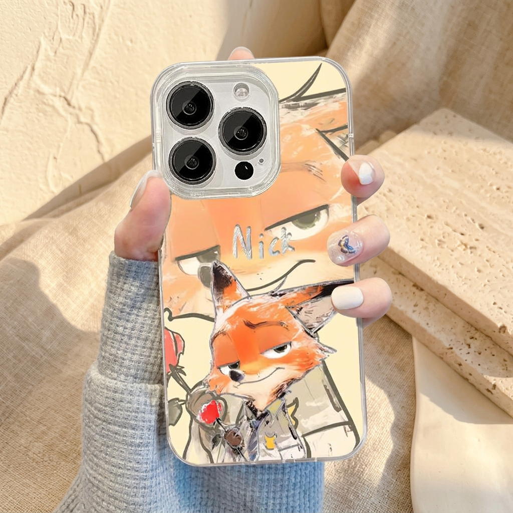 Upright Nick design case held in a grey-blue knit sleeve, showing orange-and-cream fox artwork and clear-looking camera edging.
