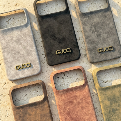 Close comparison of six suede-look Gucci design cases with wide rectangular empty camera openings and gold-tone names near the bottom.