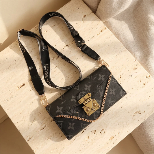 Closed Black Louis Vuitton monogram design folio with grey motifs, gold-tone clasp, short chain and black clip-on strap.