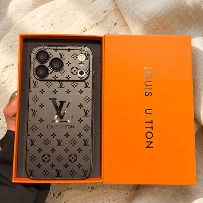 Smoky Black Louis Vuitton monogram design iPhone case in an orange presentation tray, showing dark floral motifs, a large central LV detail and a wide patterned camera panel.