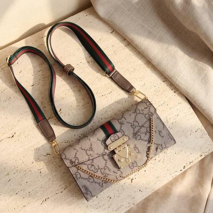 Beige-and-brown Gucci GG design folio with a green-and-red stripe, gold-tone clasp and chain, and matching striped strap.