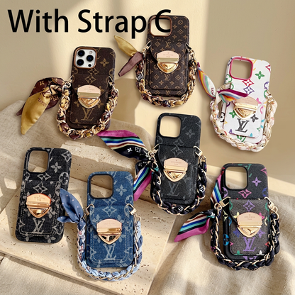 Seven monogram design rear-pocket cases with short scarf-woven chain handles and tied scarf ends in brown, black, blue and multicolour combinations.