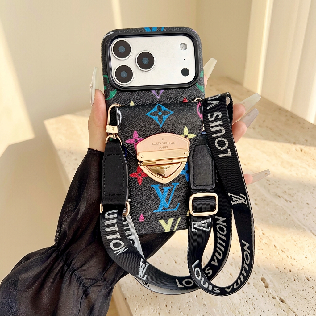 Black multicolour monogram rear-pocket case held with its long black wordmark strap, adjustment buckle and gold-tone clip hardware.