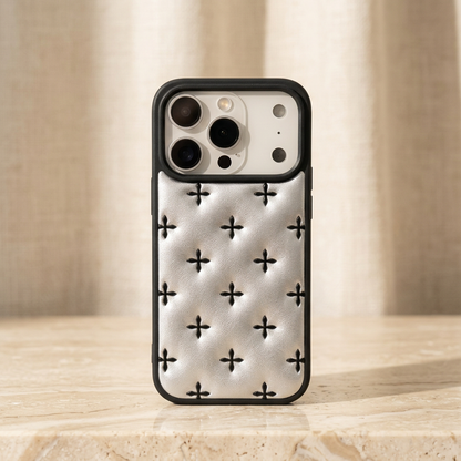 Crossquilt Puffy Faux Leather iPhone Case – Contrast Cross Design, White textured quilted back with black cross motifs and a black border in a cream studio setting.