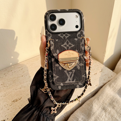 Black woven-look monogram rear-pocket case held with its gold-tone clasp and short dark-inset chain carrying LV and floral charms.
