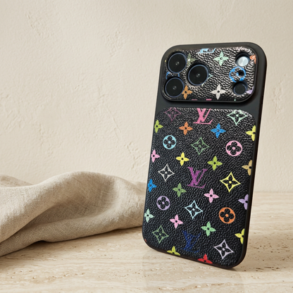 Style B black Louis Vuitton monogram design back cover with colourful LV and floral motifs on the textured rear panel and camera surround, viewed at a slight angle.