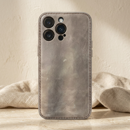 Light grey stitched rear case fitted on a display phone, with mottled grain and separate camera openings.