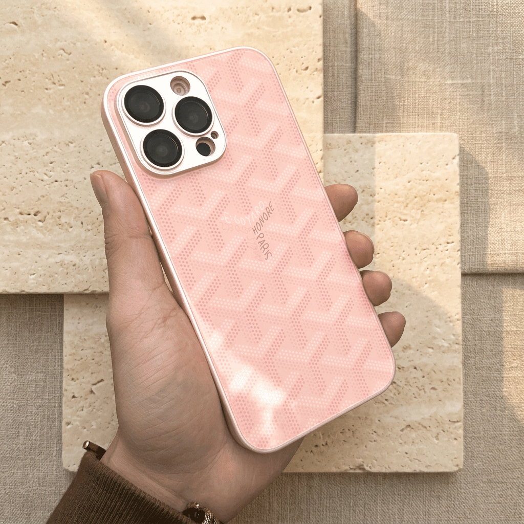 Pale pink case with a subtle low-contrast dotted chevron pattern, small central name detail and a light camera surround.
