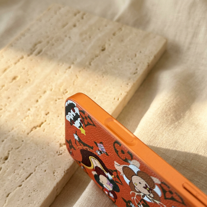Tight diagonal view of the orange festive monogram design case showing its side-control detail and part of the textured character print.