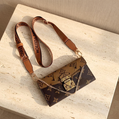 Coffee Louis Vuitton monogram design folio with a tan flap, darker brown body, gold-tone clasp and tan adjustable strap.